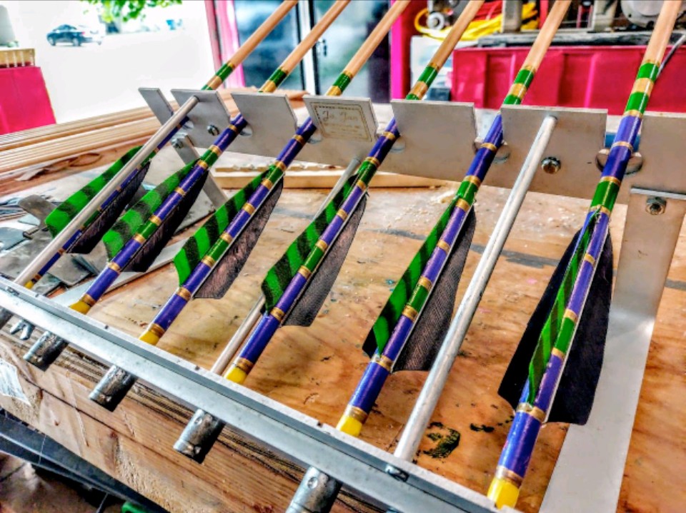 Green and purple arrows in the fletching jig