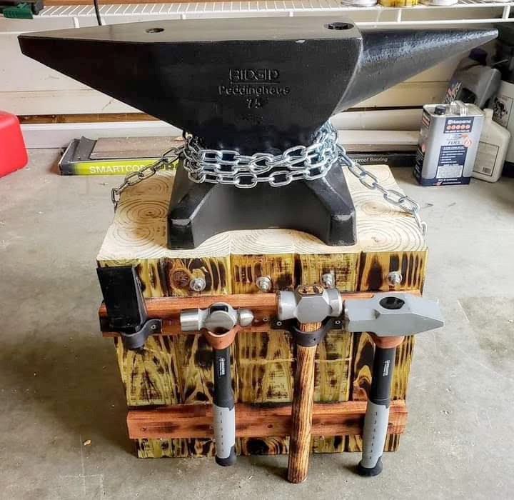 Peddinghaus anvil on a torched wood stand with magnetic hammer holders