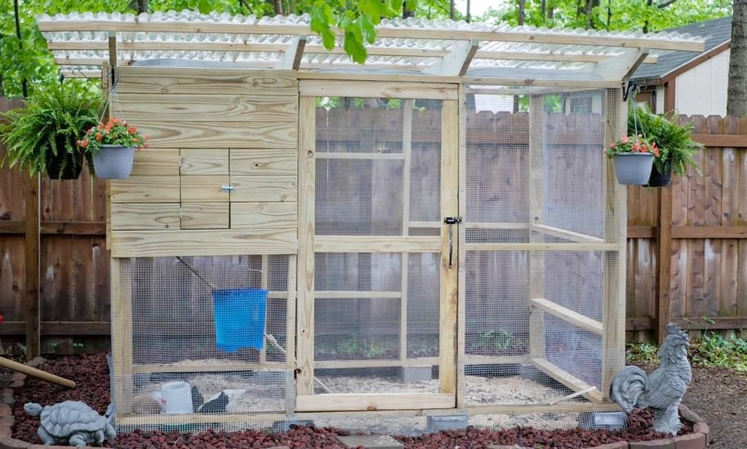 Chicken coop front view with hanging planters and landscaping