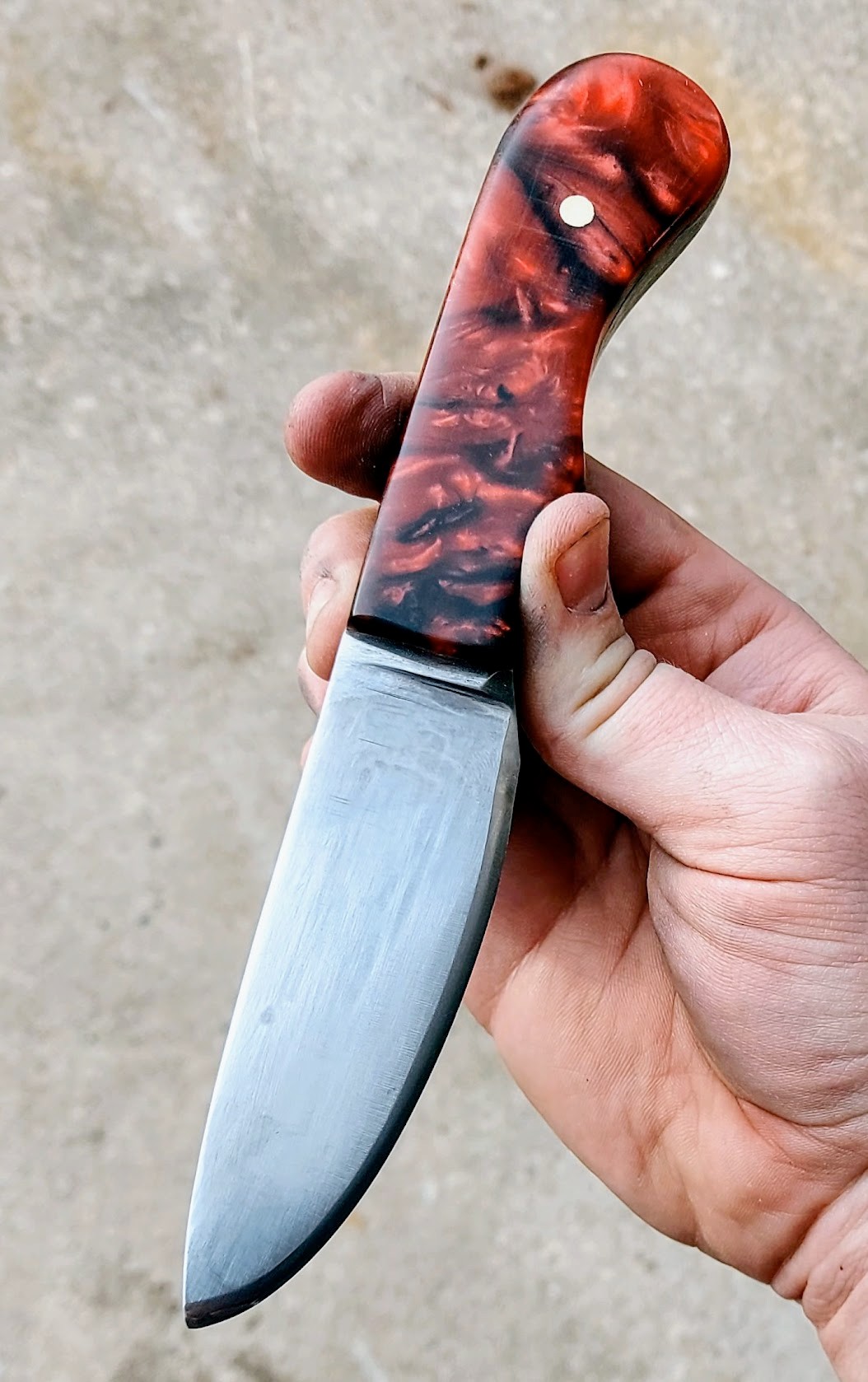 Hand-forged knife with red resin handle scales and nickel silver pin
