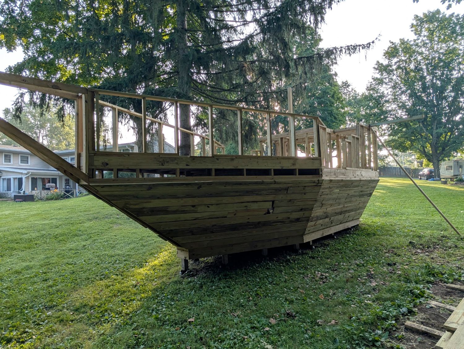 Pirate ship playhouse after staining — view from the bow with mast supports